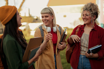 Diverse students laughing talking, enjoying friendship on campus
