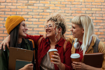 Female students chatting and laughing outside university campus
