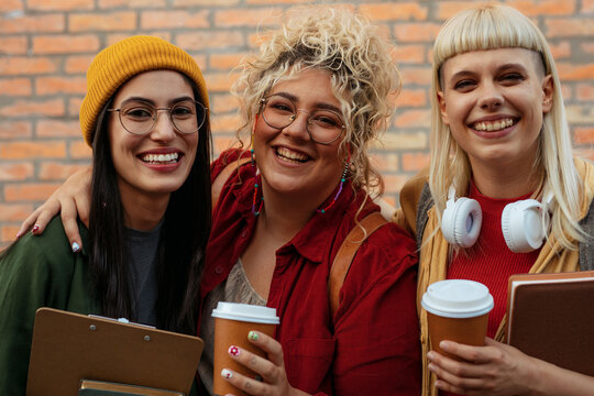 Diverse student friends smiling and enjoying coffee together - Powered by Adobe