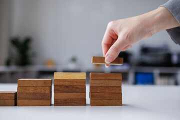 Abstract businesswomen fail danger tower block game building construction protect plan and project control.business expansion concept

