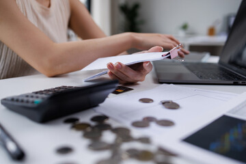 Business woman  hand freelancer managing finances and calculating costs at home office, working remotely.Technology of financial Bill pay concept.
