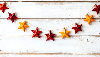 Christmas star garland hanging on rustic wooden wall. Warm festive decoration.