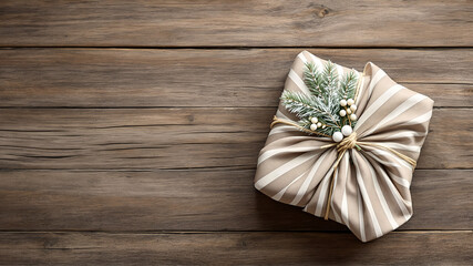 Fototapeta premium A gift wrapped in striped fabric Furoshiki style on a rustic wooden table