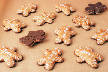Gingerbread cookies with chocolate on brown baking paper. Sweet food, Christmas concept