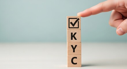 Hand checking a box on wooden blocks spelling out kyc, representing know your customer verification process
