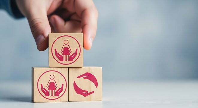 Hand stacking wooden blocks with icons representing care, protection, and recycling, symbolizing family wellbeing and sustainability - Powered by Adobe