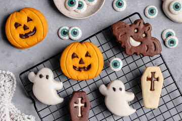 Halloween cookies on cooling rack with spooky decorations