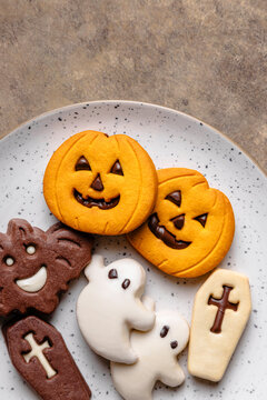 Halloween cookies on a speckled plate from top view