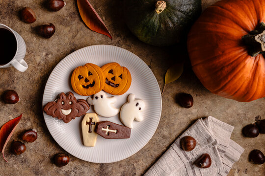 Halloween cookies on white plate with autumn decor