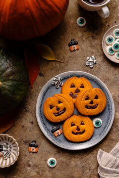 Pumpkin cookies and Halloween decorations on rustic table