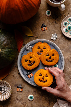 Top view of jack-o'-lantern Halloween cookies on plate