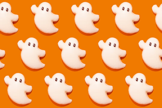 Sweet ghost cookies over orange background