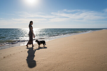Woman and dog walking on Quinta do Lago Beach