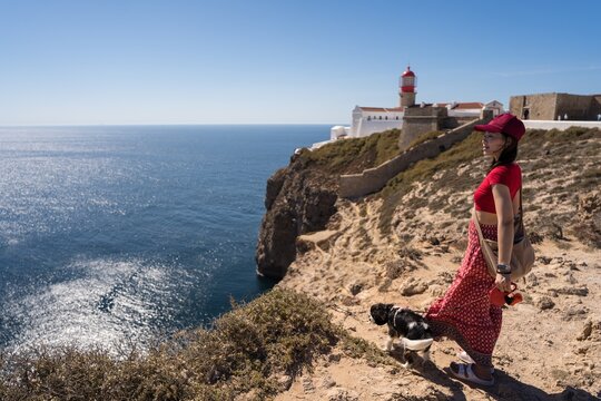 Woman and dog exploring Cabo de San Vicente cliffs