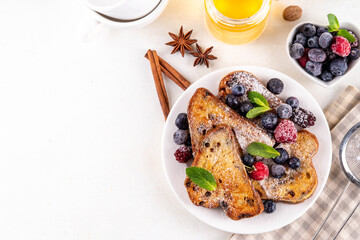 Leftover Christmas Spiced Stollen French Toasts, sweet fried stollen toasts with sugar powder and berries, Christmas morning dessert snack
