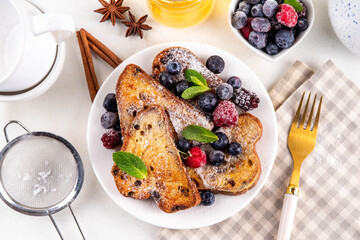 Leftover Christmas Spiced Stollen French Toasts, sweet fried stollen toasts with sugar powder and berries, Christmas morning dessert snack
