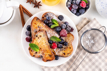 Leftover Christmas Spiced Stollen French Toasts, sweet fried stollen toasts with sugar powder and berries, Christmas morning dessert snack