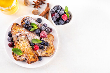 Leftover Christmas Spiced Stollen French Toasts, sweet fried stollen toasts with sugar powder and berries, Christmas morning dessert snack