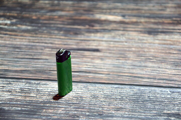 Lighter on a wooden background. Top view. Lighters on a table. Fire for cigarette.