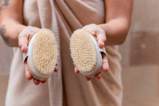 Handheld natural bristle body brushes for exfoliation