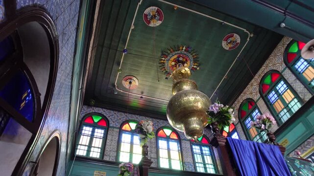 Panning footage of roof and colorful windows inside the El Ghriba synagogue, religion and historic architecture in Tunisia