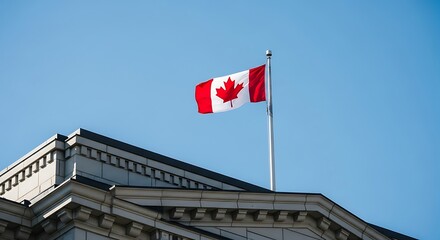 Canadian flag waving proudly on a flagpole in front of a building under a clear blue sky, symbolizing national pride and patriotism