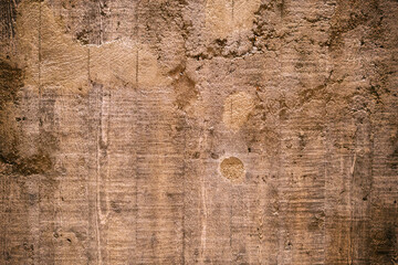 Old cracked brown concrete wall in closeup with copy space.