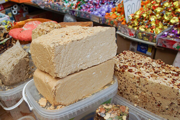 Large chunks of halva are laid out for sale at an oriental bazaar.