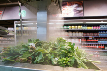 Irrigating a counter with fresh herbs using water mist.