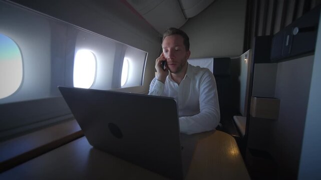 A businessman is successfully working remotely while traveling luxuriously in a private jet