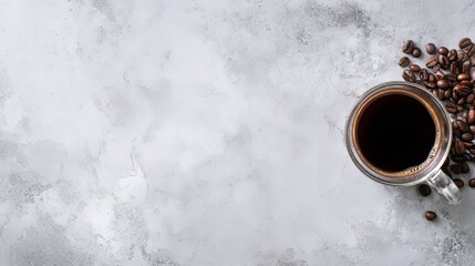 Top view of black coffee in a white glass cup placed on a rustic cement table with scattered coffee beans, illustrating morning coffee ritual, beverage enjoyment, aroma, and cozy cafe atmosphere