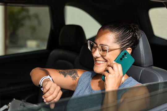 Businesswoman making a phone call in a car