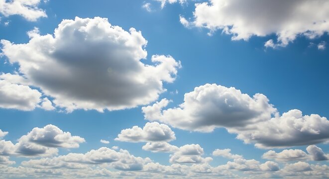 Vibrant blue sky with fluffy white and grey cumulus clouds vista