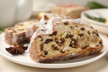 Slices of Stollen (traditional Christmas cake) served on white table, closeup