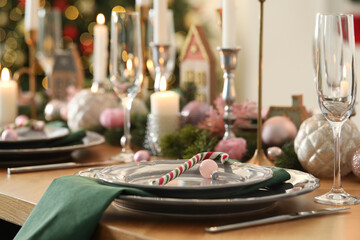 Festive table setting with Christmas decor at home, closeup