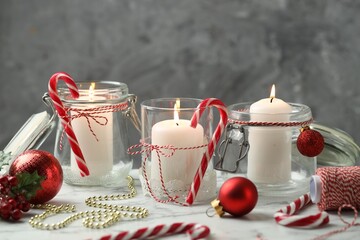 Beautiful Christmas lanterns and festive decor on white marble table, closeup