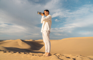 Photographer in desert capturing nature essence