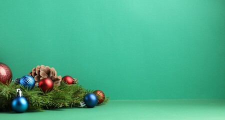 Christmas decor on green background, closeup. Space for text