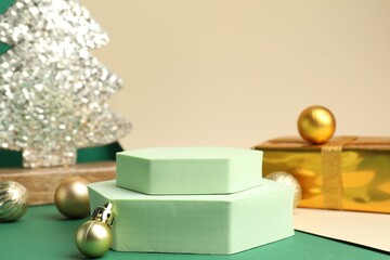 Empty podiums and Christmas decor on color background, closeup. Space for text