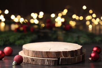 Empty podiums and Christmas decor on wooden table against blurred lights, space for text. Bokeh...