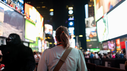 Woman exploring vibrant Times Square at night