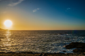 Fototapeta premium Golden Sunset Over Rocky Coastline