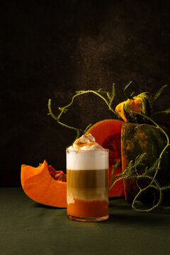 Rustic autumn pumpkin spice latte with decorative gourds