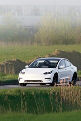 Fototapeta premium Clean energy car driving countryside road