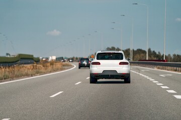 SUV driving on a straight empty road.