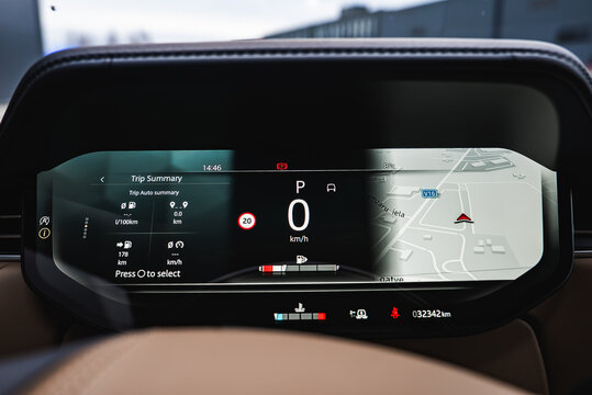 Close up of a digital instrument cluster shows 0 kmh in Park, trip data, and a 3D map with V16 and Maza iela in Latvia, 8 C at 14 46, odometer 32342 km, and status icons