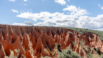 Eroded sandstone cliffs under clear blue skies