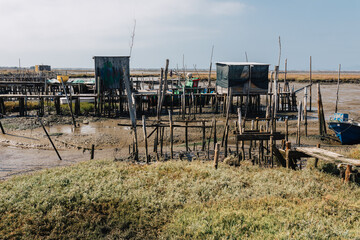 Coastal fishing village with wooden structures and boats