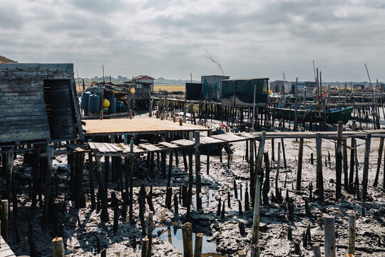Wooden docks and boats in a drying coastal area