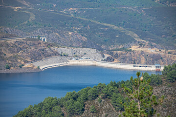 Panoramic view of the reservoir after the rain with low clouds skimming the water's surface and creating a melancholic atmosphere